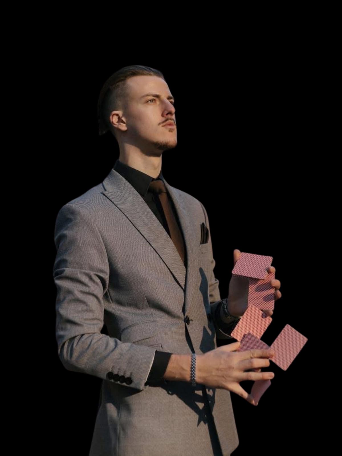 Mentalist in a grey suit with playing cards